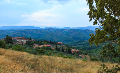 Tuscany, Italy - August 26, 2009: A picturesque view of a village in the Chianti Classico region,  with rolling hills, vineyards, and charming stone buildings under a serene sky