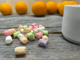Beautiful, airy, pale white marshmallows on a wooden plate.