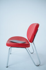 laptop on the red armchair