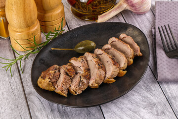 Roasted duck breast slices in the plate