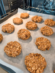 Freshly baked oatmeal cookies cooling on baking sheet