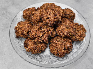 Delicious homemade oatmeal cookies resting on elegant glass plate copy space