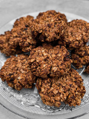 Freshly baked oatmeal cookies resting on a glass plate
