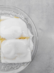 Creamy dessert squares Semolina cake resting on elegant glass plate copy space