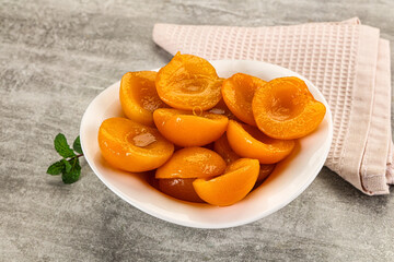 Sweet canned apricots with syrope