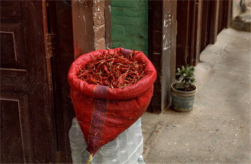 A sack of dried  red chillies for sale on a doorstep