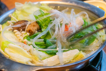 A steaming hot pot feast brings together fresh ingredients and rich flavors in a warm, communal...