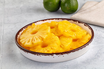 Sweet canned pineapple slices in syrope