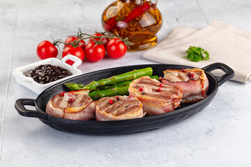 Tasty grilled pork medallion with bacon