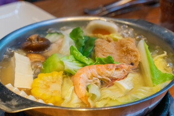 A steaming hot pot feast brings together fresh ingredients and rich flavors in a warm, communal dining experience. The bubbling broth, infused with aromatic spices, serves as the perfect base for cook