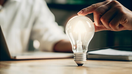 mental heath awareness. close up of a lightbulb being gently placed on a desk