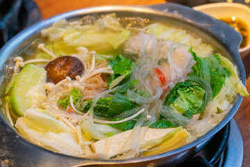 A steaming hot pot feast brings together fresh ingredients and rich flavors in a warm, communal...