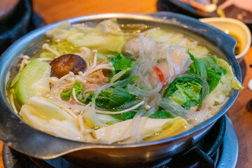 A steaming hot pot feast brings together fresh ingredients and rich flavors in a warm, communal...