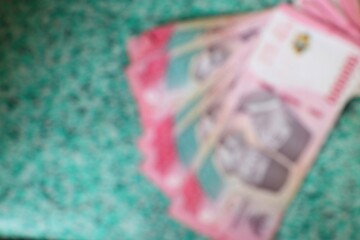 Blurred close-up shot of Ukrainian Hryvnia banknotes on a textured surface