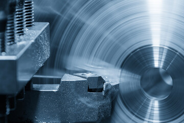 Closeup scene the lathe machine finish cut the metal parts in the light blue scene.