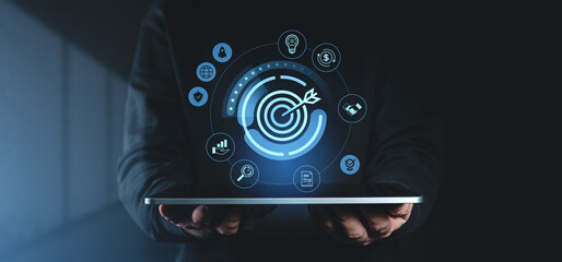 Business target concept with digital icons and aim symbol on tablet.