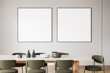 Minimalist dining room with two framed blank posters on light wall. 3D Rendering