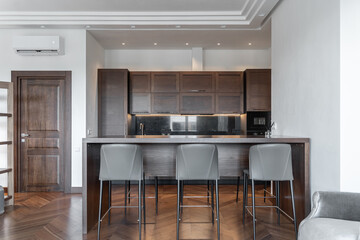 design of stylish modern kitchen with wooden furniture. kitchen with induction on counter....