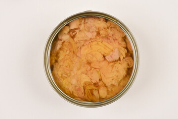 A top-down shot of an open can of tuna in oil on a white background