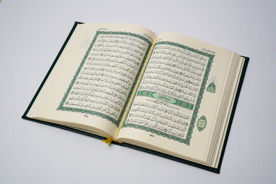 An open Quran displaying Surah Al-Kahf, a chapter of wisdom and guidance, often recited on Fridays by Muslims worldwide