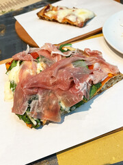 Parma ham pizza with cheese and rocket salad.