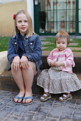 Two cheerful sisters outdoors portrait