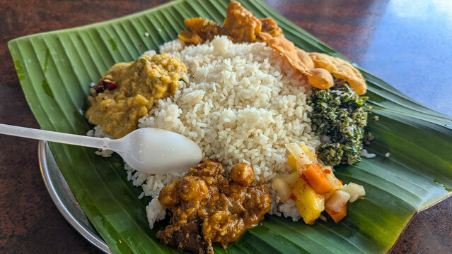 Closeup of traditional Sri Lankan food cuisine rice and curry on banana leaf in Sri Lanka