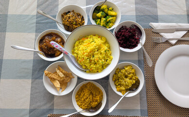Top down view of Sri Lanka vegetarian cuisine food of rice, curry, and roasted vegetables served in a selection of bowls