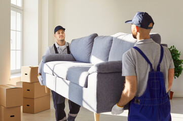 Young mover men service sofa furniture moving, individual, company workers carry, load possessions,...