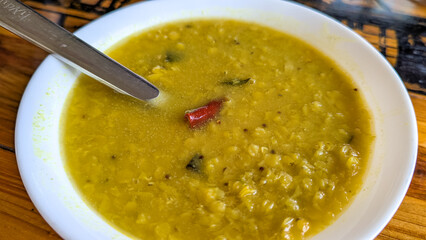 Closeup of Sri Lankan lentil dahl curry cuisine food with spicy red chili pepper served for breakfast