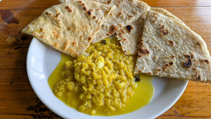 Sri Lankan food cuisine of lentil dahl curry served with roti bread served for breakfast at local restaurant