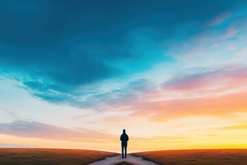 A person stands at a crossroads in a serene landscape, contemplating which path to take under a beautiful sunset sky
