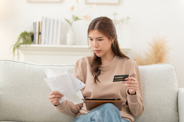 Asian woman feeling unhappy after looking bill feels stressed having financial problem, check...