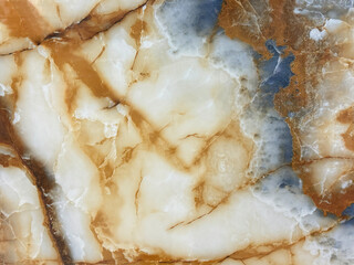 Natural brown marble with dark golden red veins and blue color shades. Luxurious rare type brown gold natural marble stone, Seamless background texture.