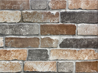 Red orange brickwall texture on an exposed wall with cement and natural contour. Vintage red and...