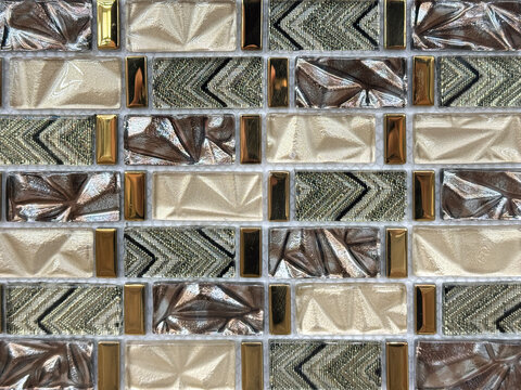 Close up of silver and bronze glass mosaic tiles. Bronze copper metallic mosaic tiles are symbol of luxury and elegance, usually used in bathroom or luxurious hotel.