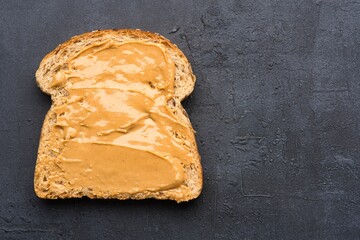 Delicious and healthy peanut butter on black background