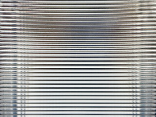 Texture of horizontal fluted glass, or striped glass, with the refraction of lights behind it....