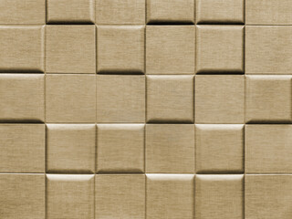 Close up of 3d wall panel in square checkerboard or checkered pattern, in bright shiny gold color. 3D beveled checkered shape used for wall sound insulation. Seamless background texture.