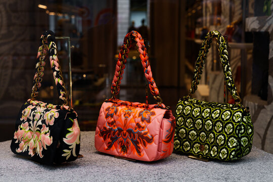 Milan, Italy - 24.04.2024: Vibrant designer Etro handbags in a fashionable storefront display.