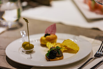 Elegant gourmet appetizers served on white porcelain.