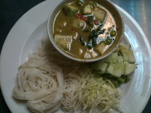thai style noodle, Thai Rice Noodles in spicy Thai green curry on black table,  Kanom Cheen kang keaw wan, Fresh Thai rice noodle Served with vegetables, eggplant, chillies and basil. Thai food