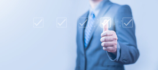 Businessman checklist concept as clipboard document checklist form on the virtual screen Use your hands or a pen to check the correct control gaps and check the quality standards of the work.	
