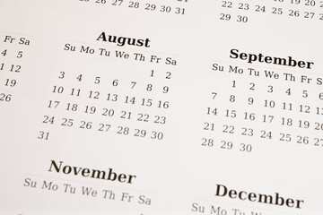 Fototapeta premium Close-up of a printed calendar displaying August, September, November, and December 