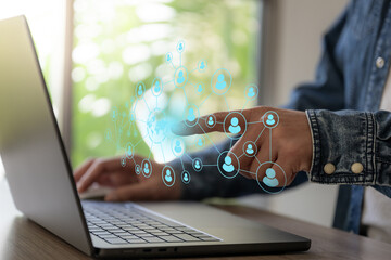 The Business man hold the icon of people networking around the world.