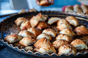 Uzbek Samsa or Sambousak oriental meal stuffed with meat, cheese or vegetables at street market...
