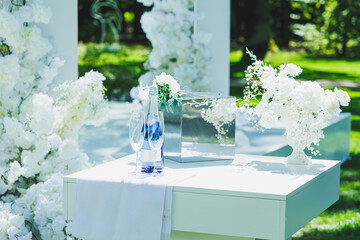 A table adorned with white flowers and a bottle of water