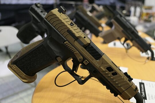 Modern turkish automatic pistol Canik TTI Combat displayed on safety stand on Hunting Expo in Nitra, Slovakia, march 2025. 