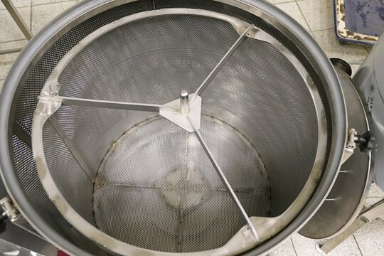 Top down view of interior of electrically heated wax melter with centrifuge, used by beekeepers to produce beeswax.