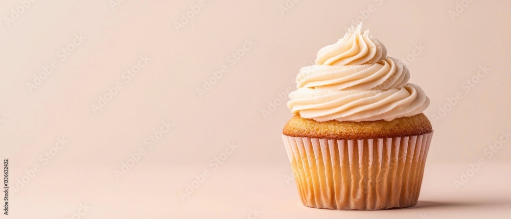 Fototapete the image is of a cupcake with a light orange frosting. the cupcake is in a paper liner and is place